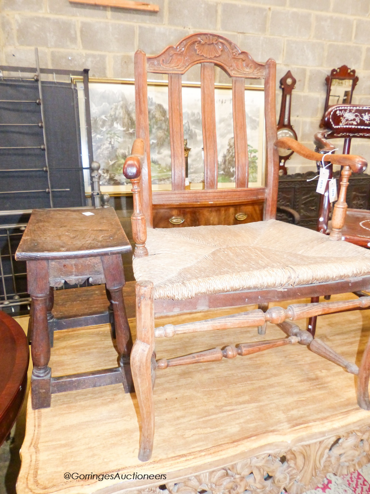 An early 18th century oak rectangular topped stool and an oak lathe back elbow chair (2)